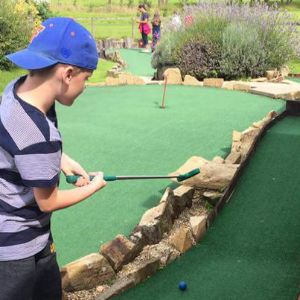 Child playing crazy golf at York golf range