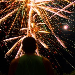 Man watching a sky full of fireworks