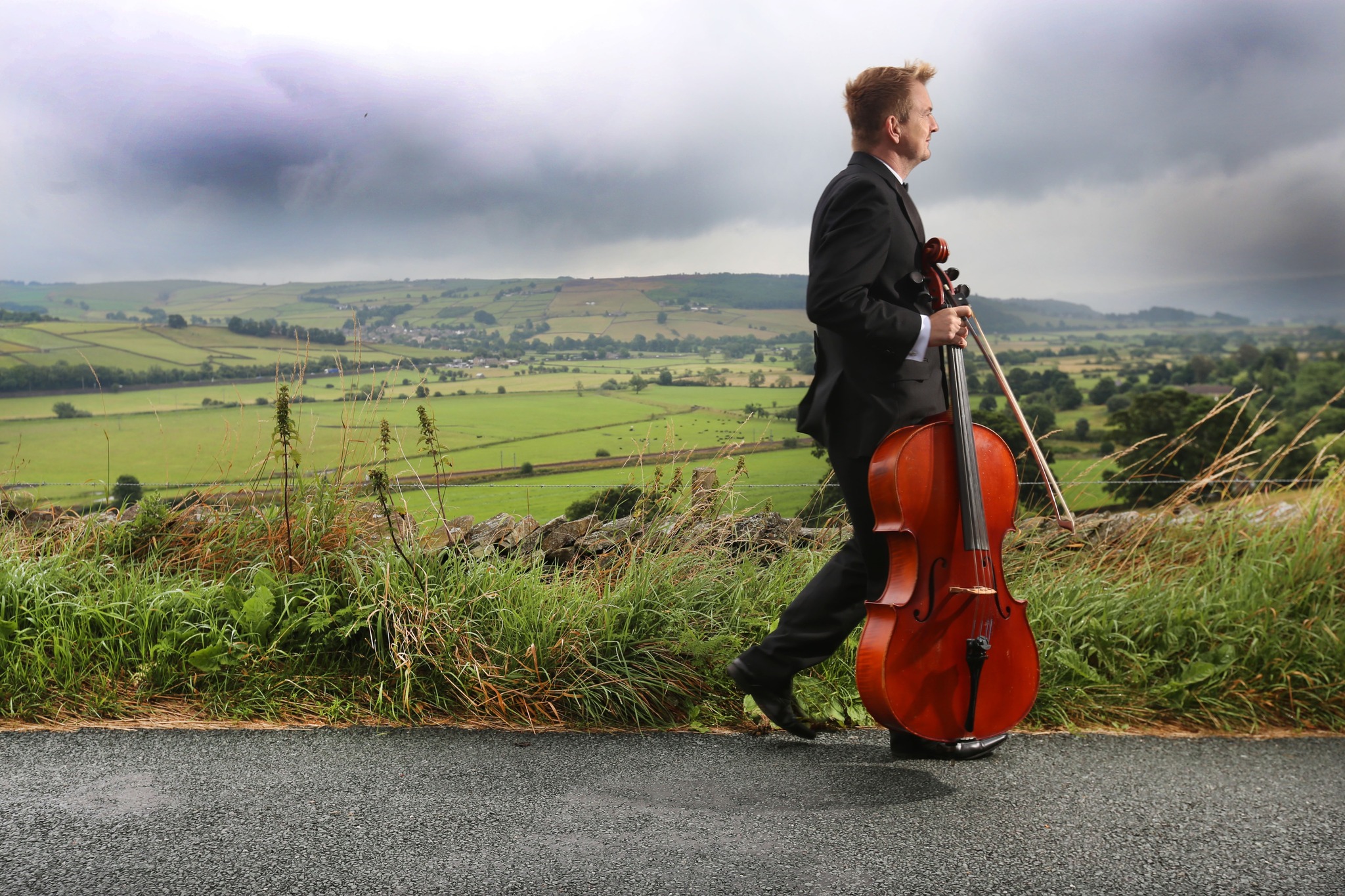 Cello Player walking theough Yorkshire Countryside