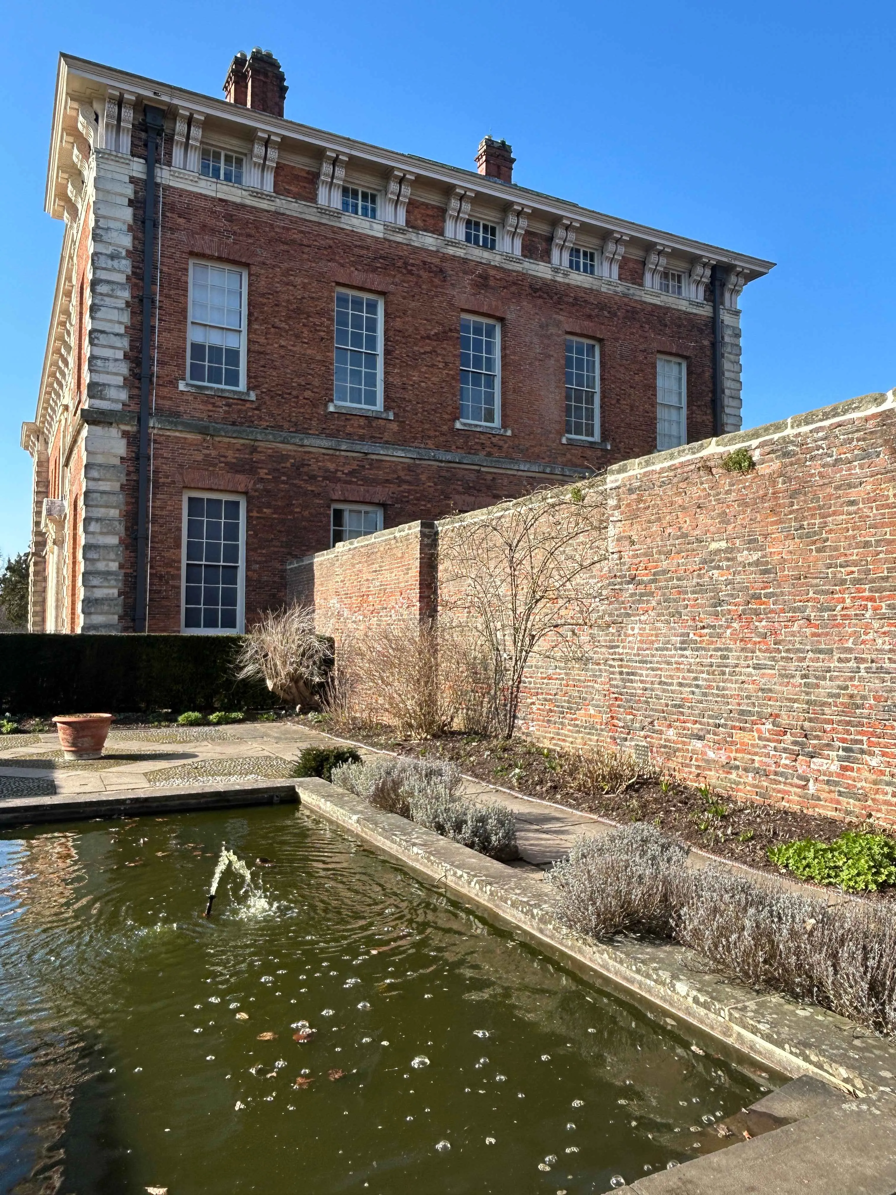 side view of the hall with the fish pond in the foreground