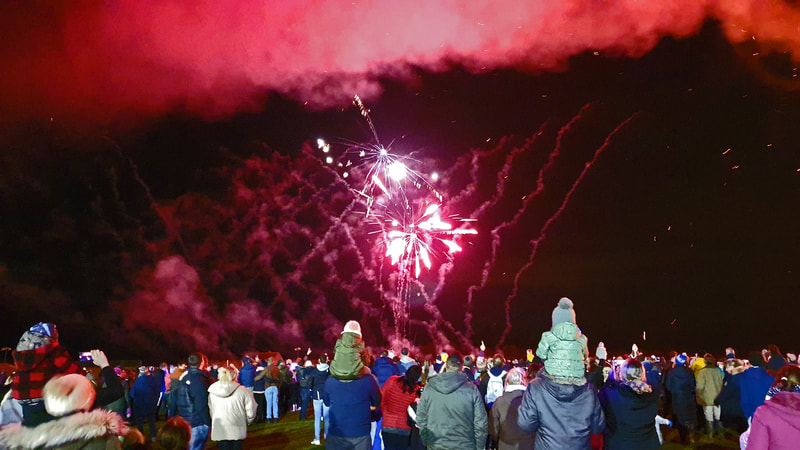 crowds of people watching fireworks