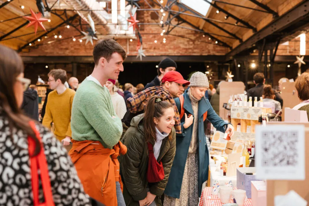 pair of young people looking intently ata craft stall