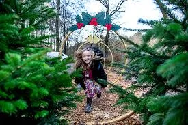 young girl running through twelve gold rings in strid wood