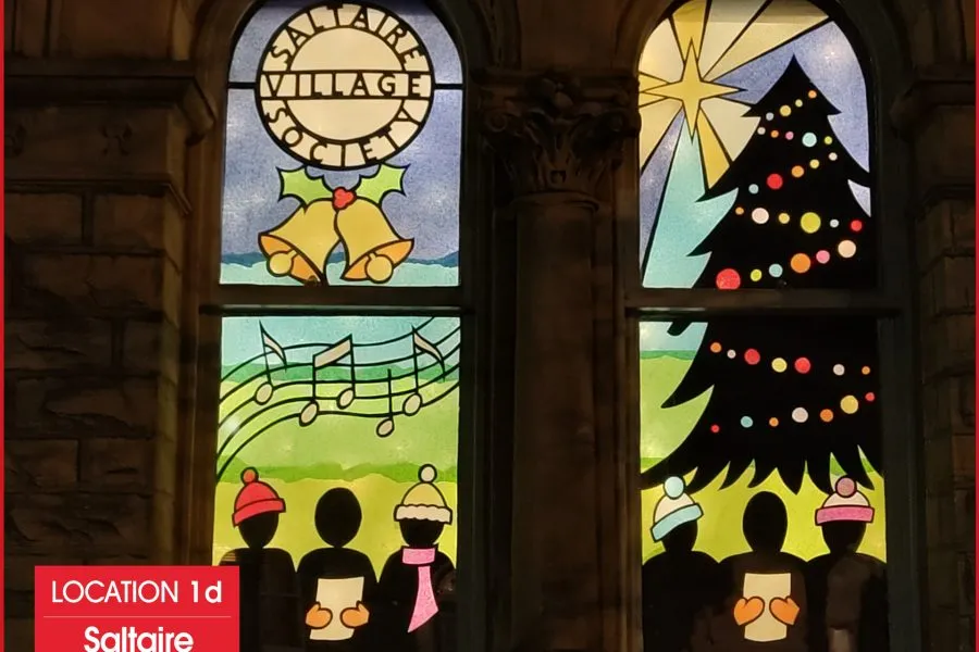 window with christmas carol scene.