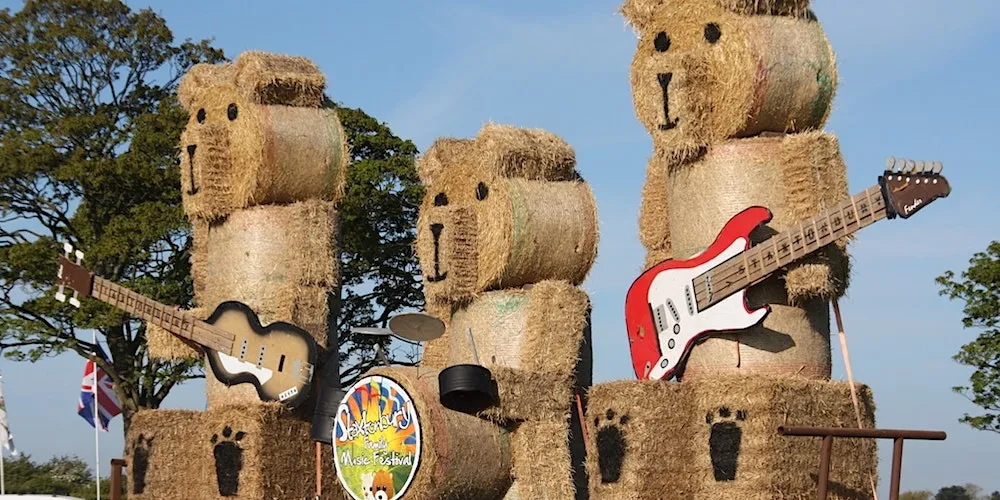 bears made from hay bales with musical instruments
