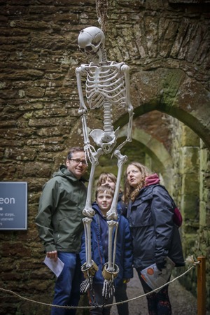 family at bolton castle with skeleton