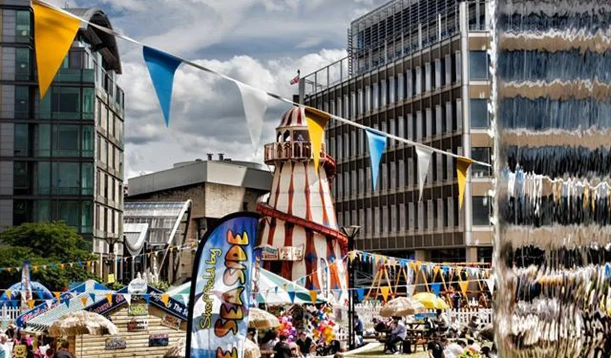 Sheffield by the sea event in the peace gardens, with helter skelter, beach and water fountains.