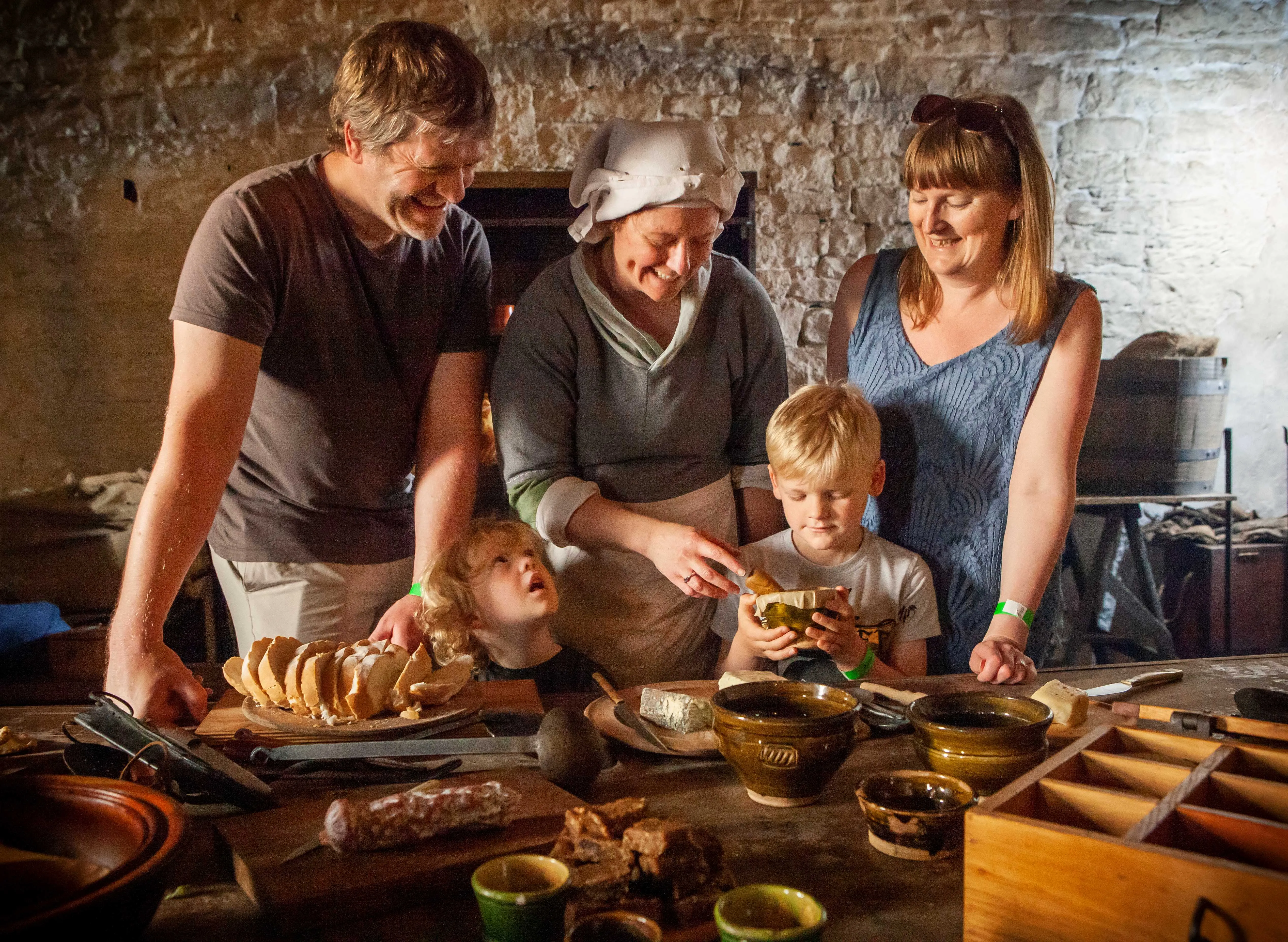 family with a re-enactor looking at medieval foods and breads