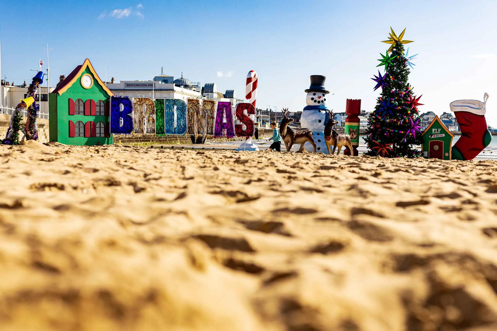 Bridmas sign, and christmas items on Bridlington beach in the summer.