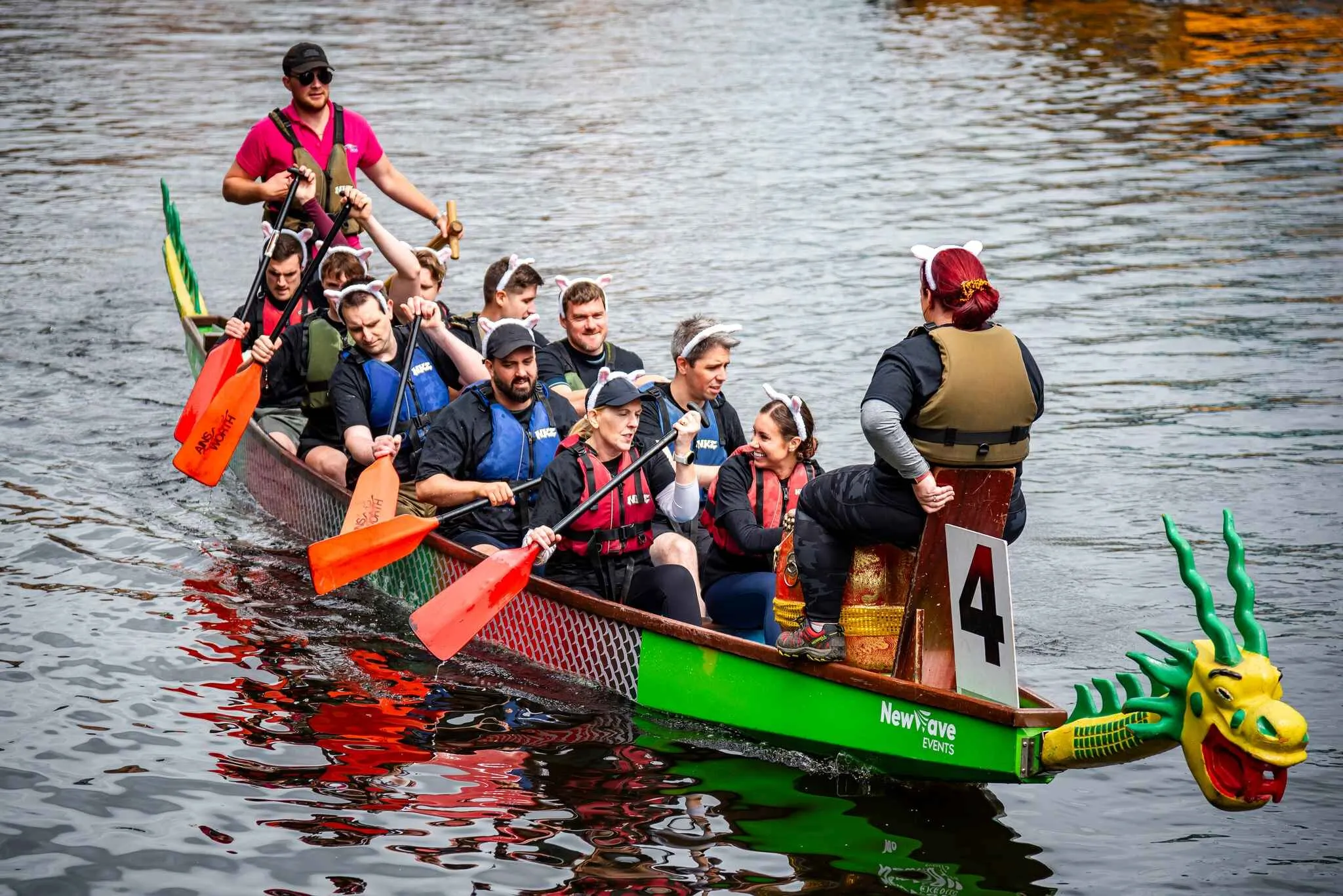 crew in a dragonboat with a bright green dragon head.