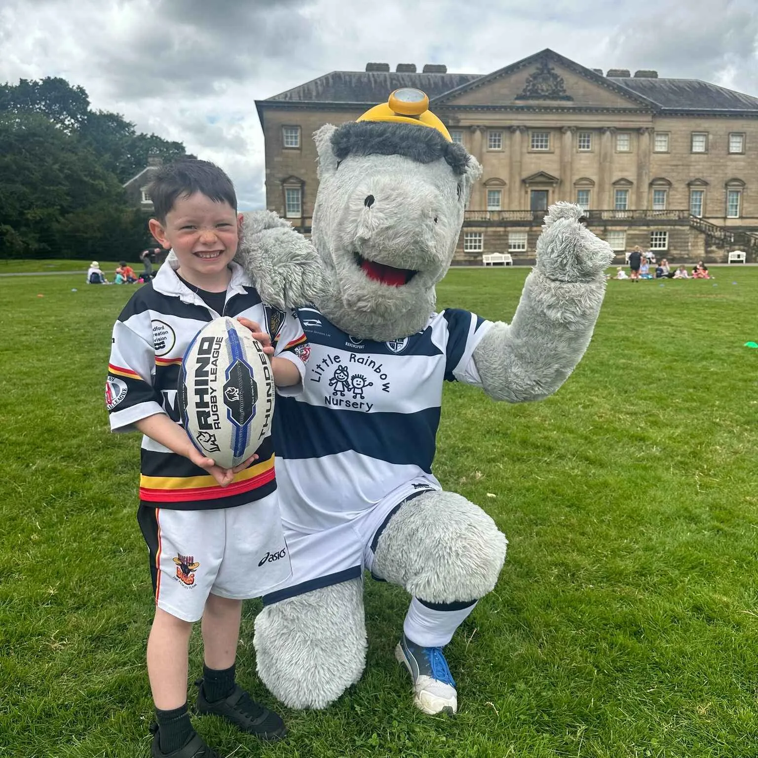 Featherstone rovers mascot with a small boy in front of Nostell Priory.