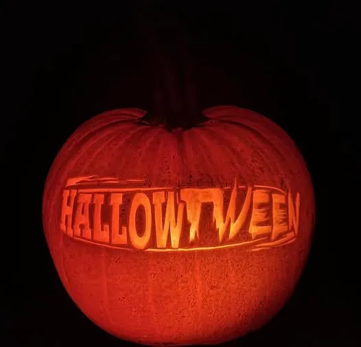Pumpkin with Hallowtween carved into the flesh