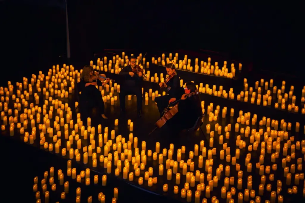 string quartet surrounded by candles