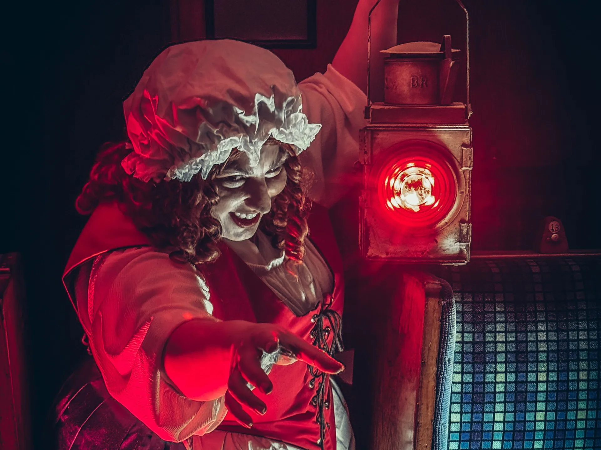 Mad Alice character holding up a lantern and leering towards the camera